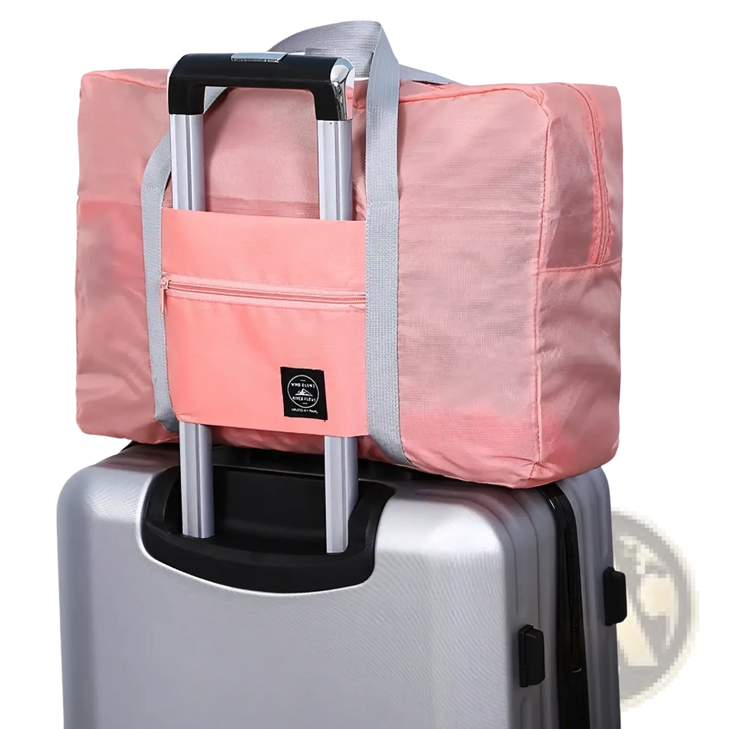 Pink foldable travel duffle bag with gray straps and front zippered pocket made of lightweight nylon for travel convenience