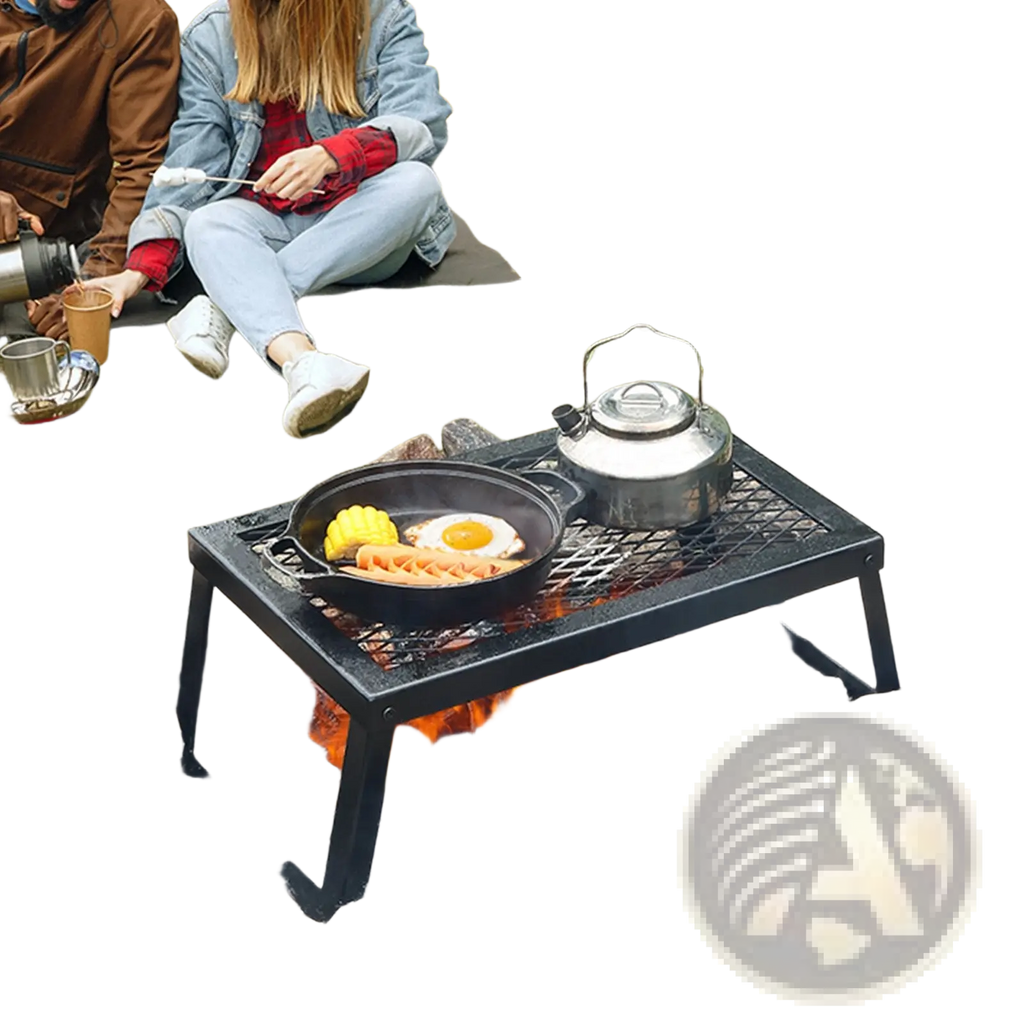 Black metal folding campfire grill with heavy duty steel mesh grate and legs positioned over open fire surrounded by rocks