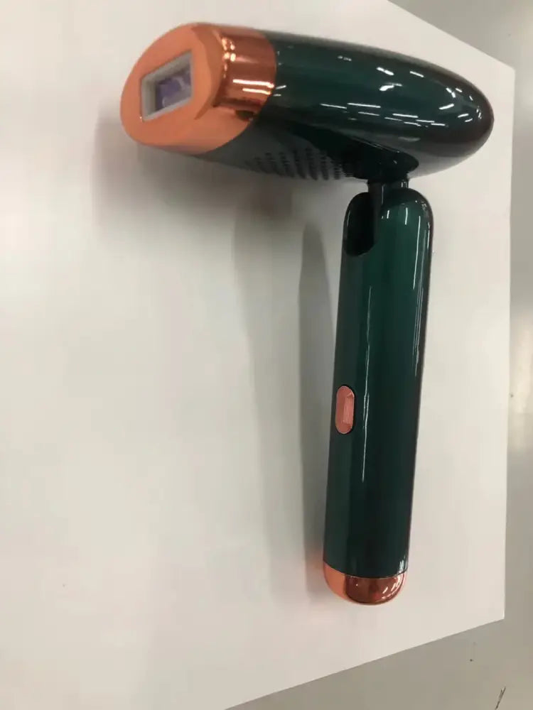 A sleek dark green and copper folding ipl laser hair removal device with compact design and glossy finish