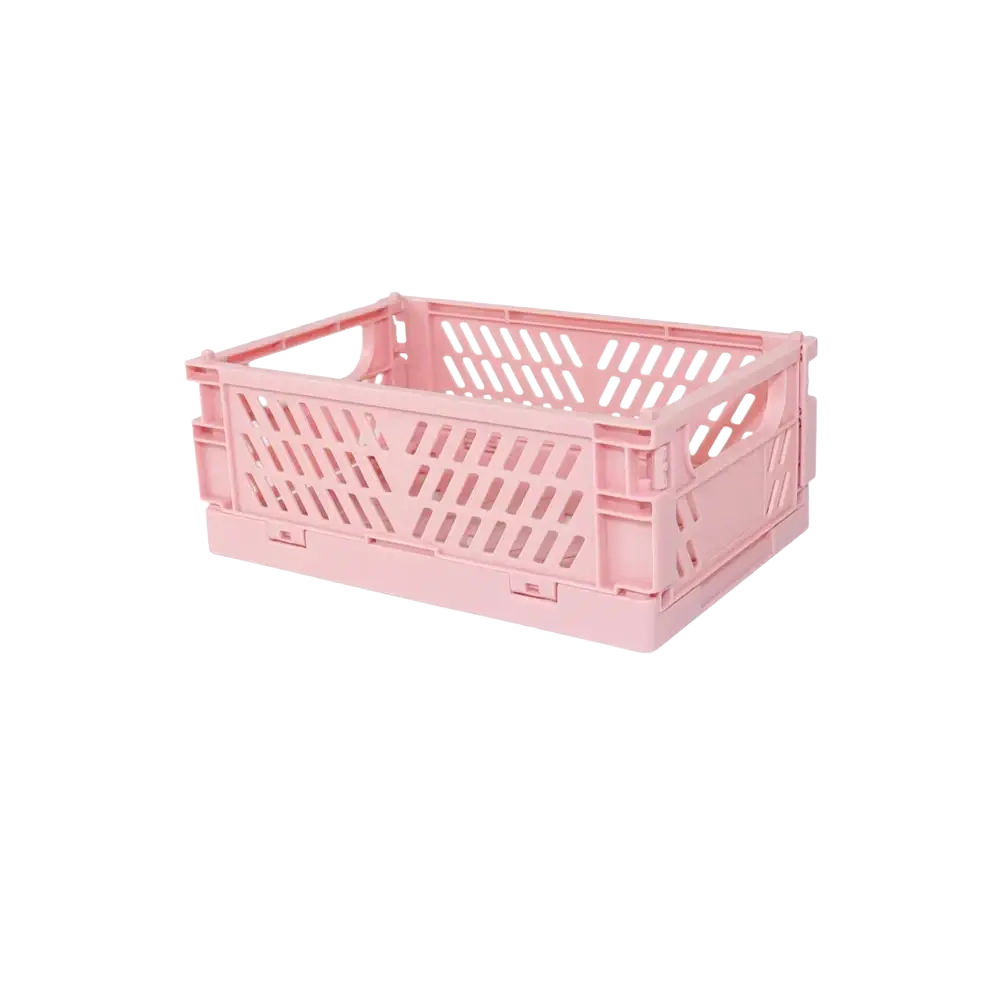 Pink plastic folding storage box with diagonal slotted sides designed as a pastel desktop organizer basket