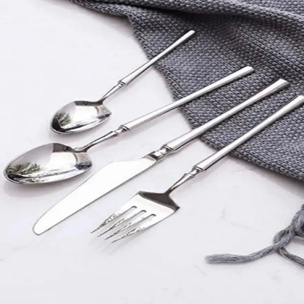 Modern 4-piece stainless steel steak cutlery set with bamboo-inspired handles in silver and natural brown colors