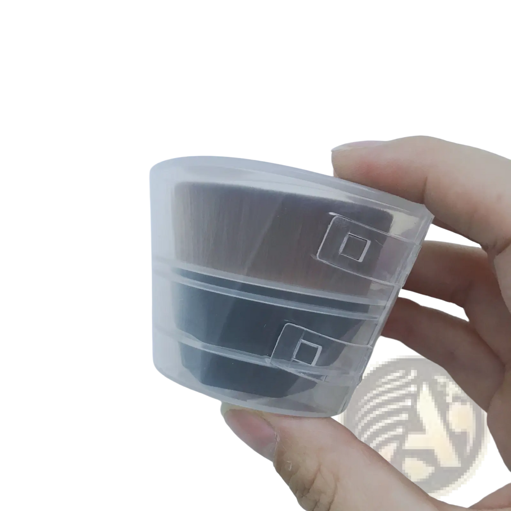 Clear plastic case holding two black cassette tapes as a foundation brush and powder makeup set with case