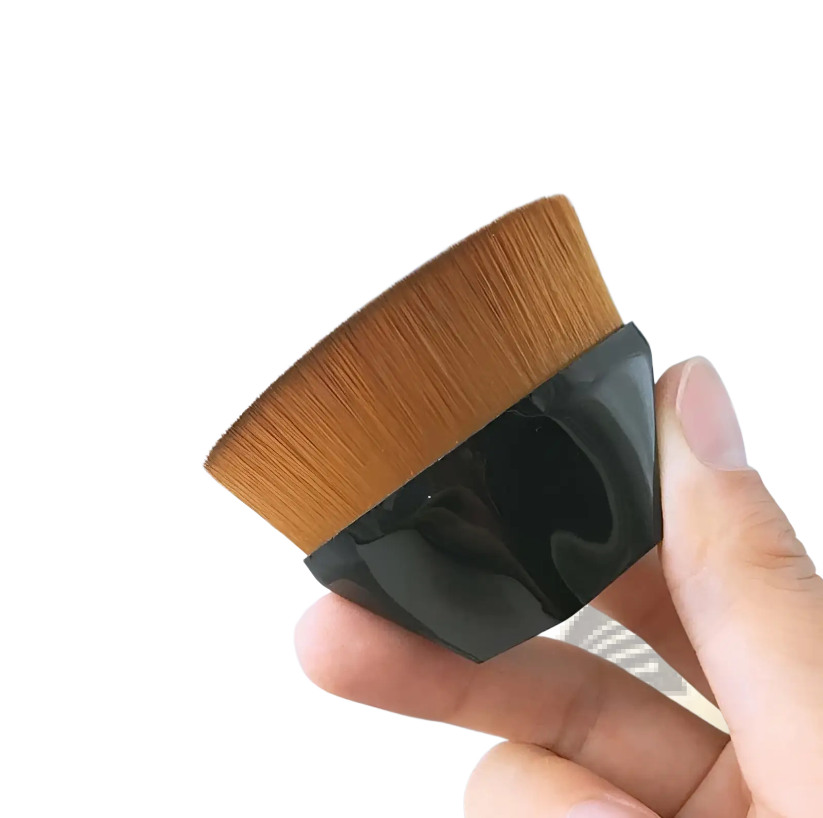 A sleek black-handled foundation brush with dense golden-brown bristles in a powder makeup set with case