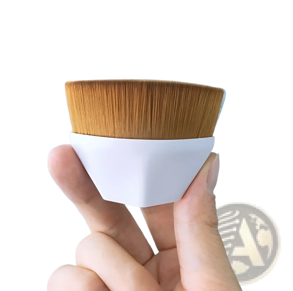 A sleek white hexagonal foundation brush with dense golden-brown bristles for powder makeup application