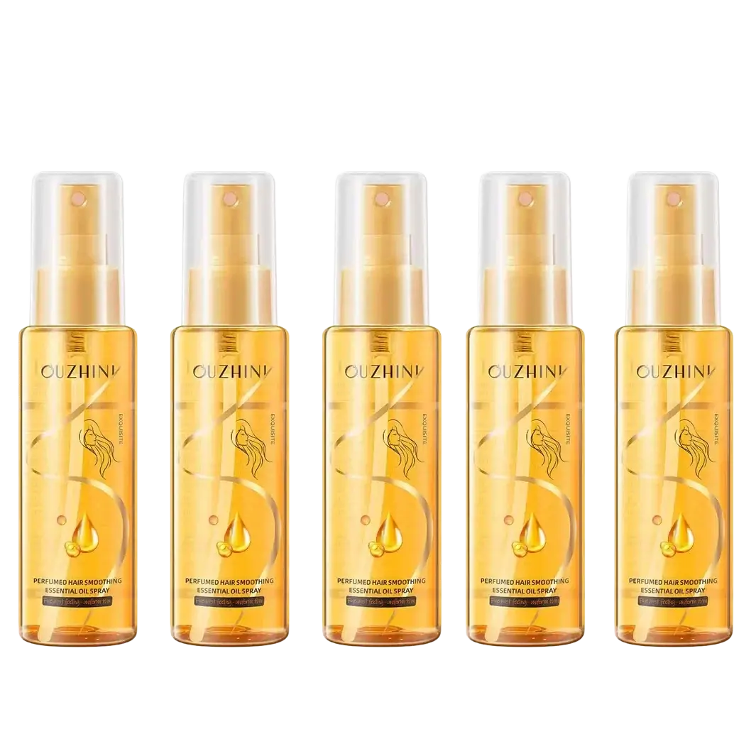 Five transparent amber glass bottles of Ouzhini fragrance hair care essential oil spray with gold spray nozzles and caps