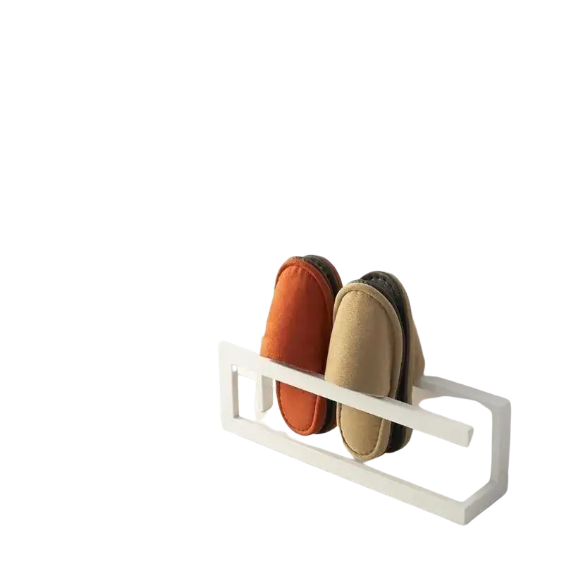 White minimalist freestanding metal shoe rack holding a pair of orange and beige slip-on slippers space saving holder
