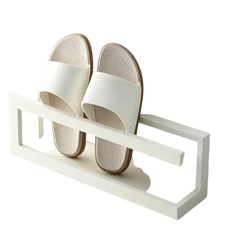 White minimalist slippers with textured insoles and brown rubber soles on a freestanding metal shoe rack space saving holder