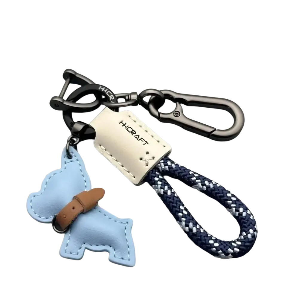 French bulldog leather keychain in light blue with brown collar detail attached to navy white braided rope loop