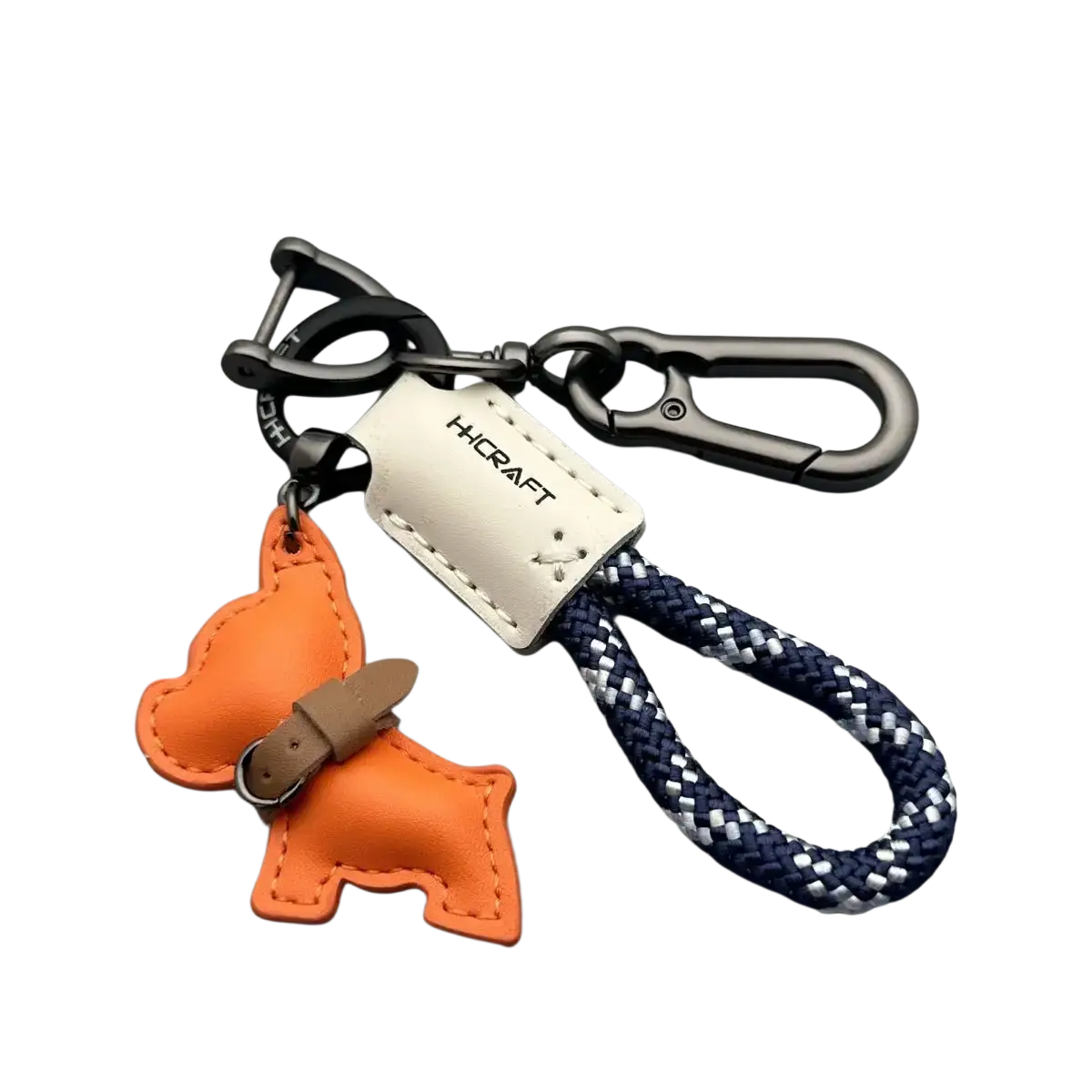 Orange leather french bulldog keychain with tan belt detail and navy blue braided rope loop for keys