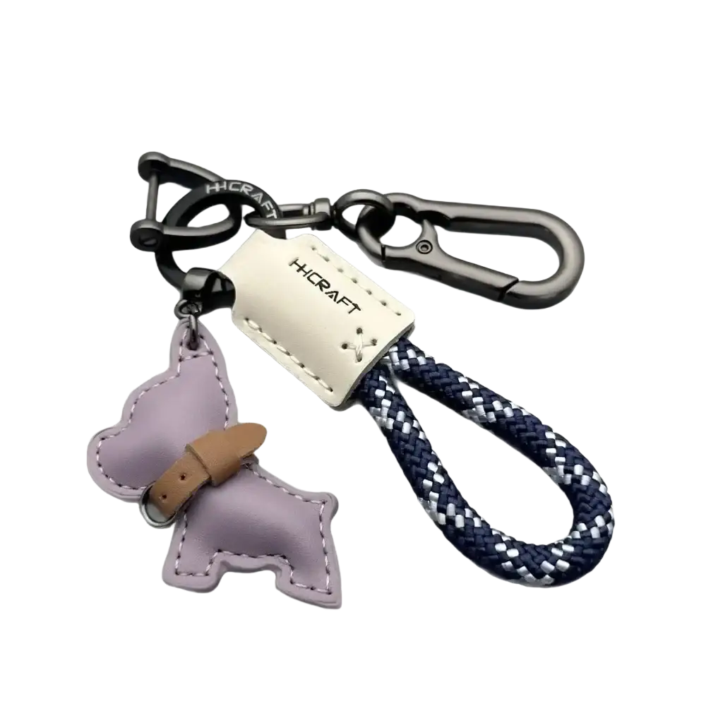 French bulldog leather keychain in purple with tan collar detail attached to navy and white braided rope strap