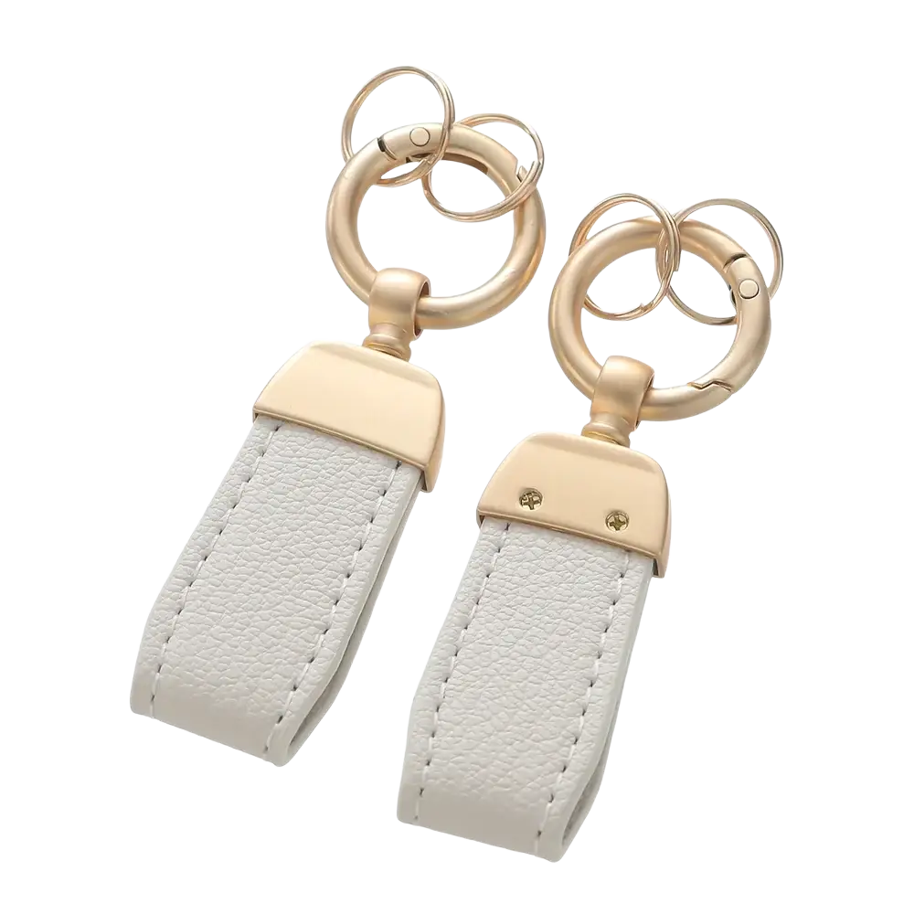 White french sheepskin leather car key chain pendant with gold-tone metal hardware and minimalist design