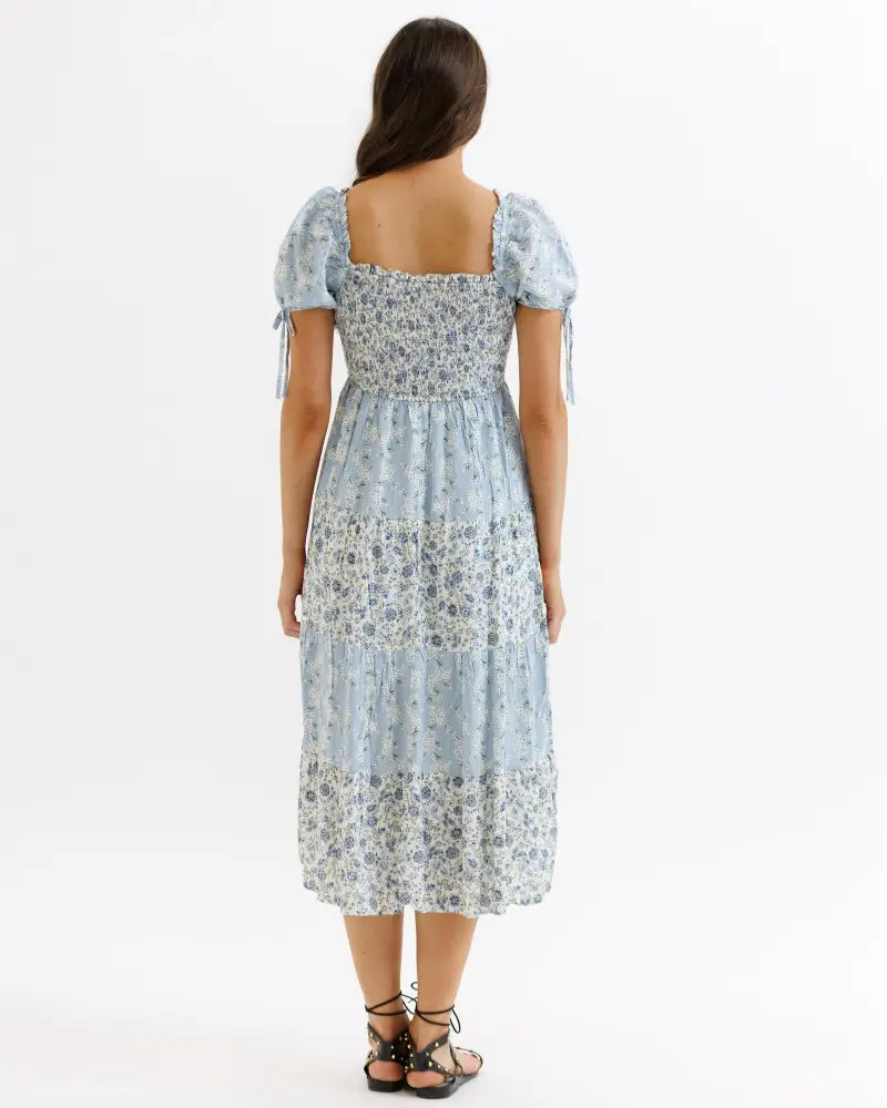 A light blue floral tiered midi dress with puffed sleeves and square neckline from Fresh Bouquet