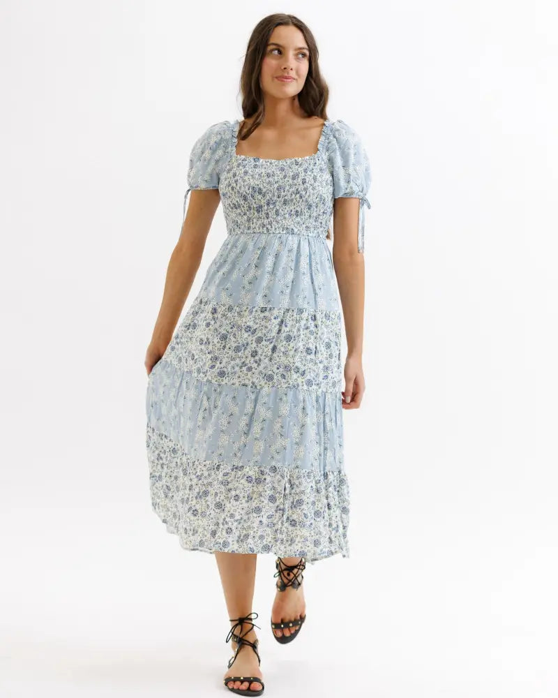 A light blue fresh bouquet floral tiered midi dress with square neck and puffy short sleeves