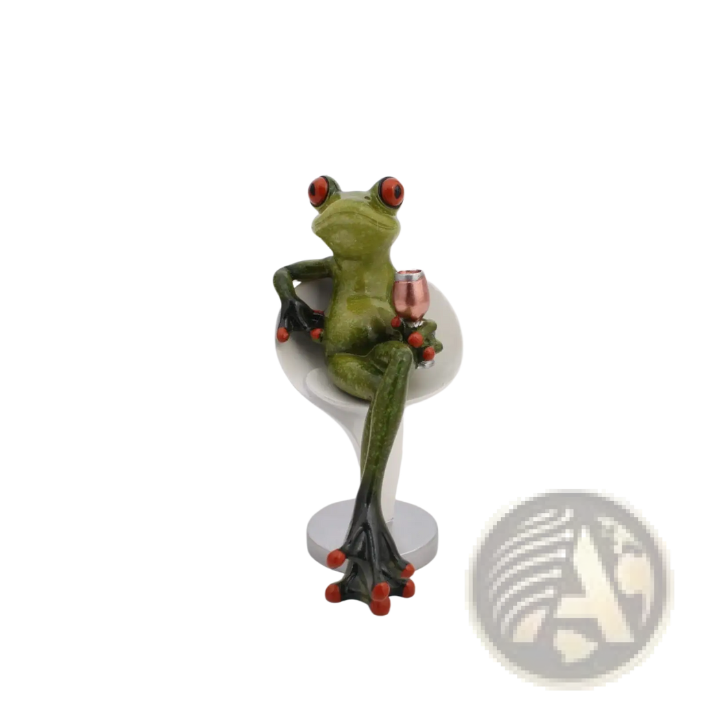 Green frog resin figurine with red eyes and orange toe pads seated in white wine glass holding rose gold miniature glass