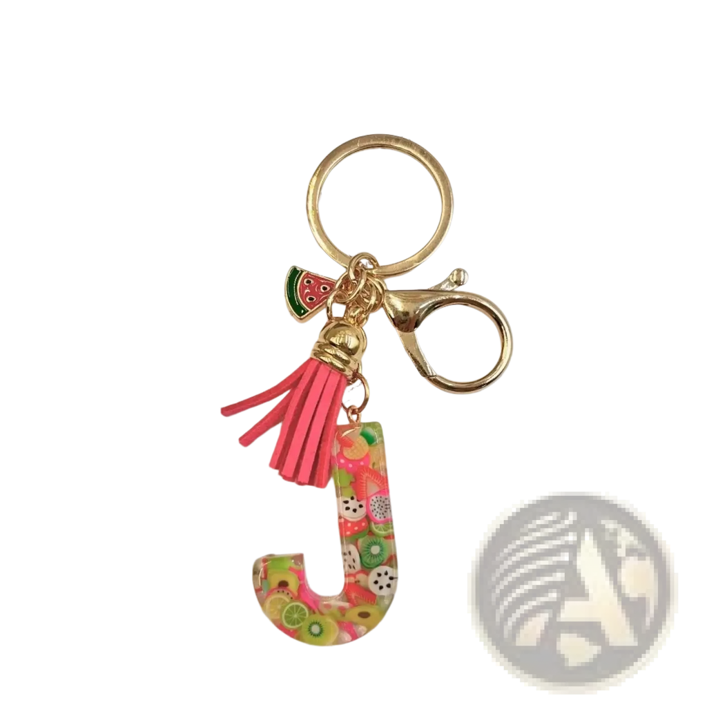 A vibrant translucent resin letter j keychain with colorful fruit slices and a pink tassel for alphabet initials