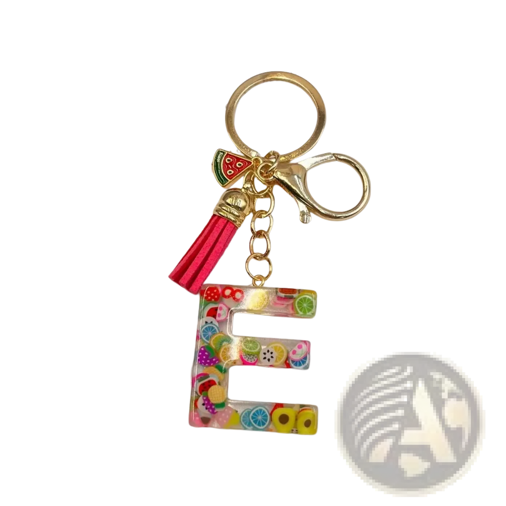A vibrant transparent resin keychain letter e with colorful fruit slices and gold ring clasp with pink tassel