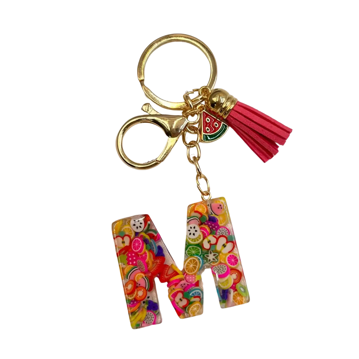 A vibrant translucent resin keychain shaped like letter m with colorful fruit slices and patterns in a glossy finish