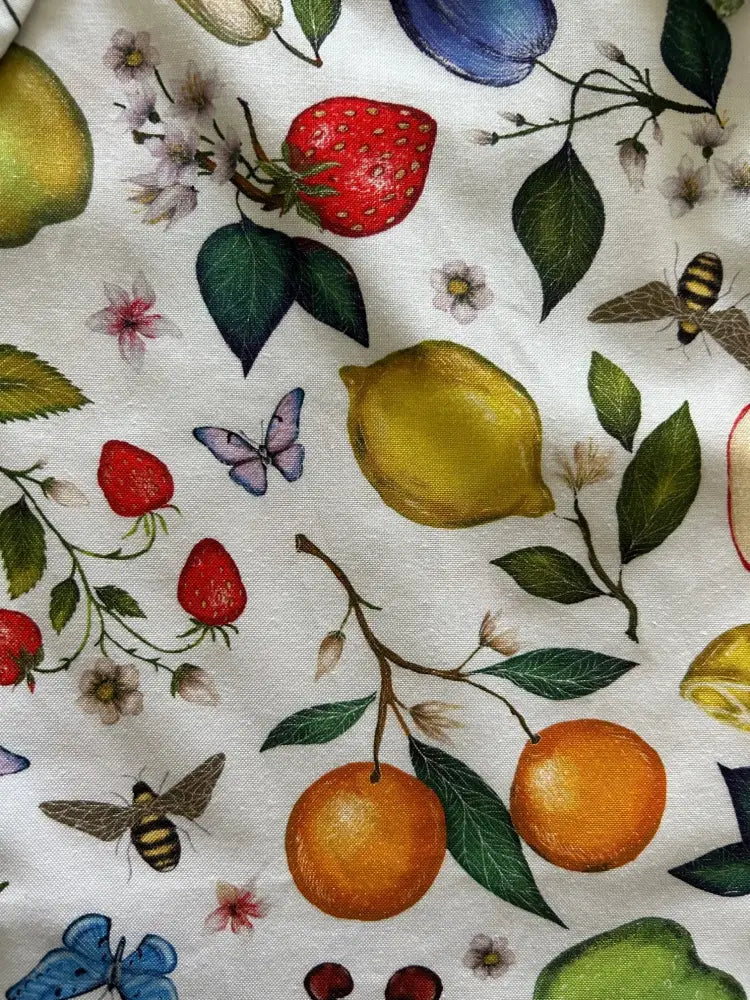 White cotton bow top with colorful vintage fruits print including strawberries lemons oranges butterflies and bees