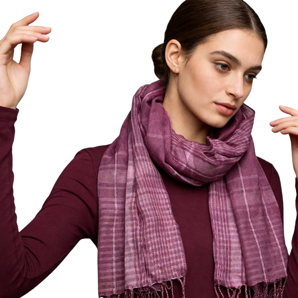 A soft textured purple plaid yarn-dyed scarf with fringed edges in fuchsia color block design