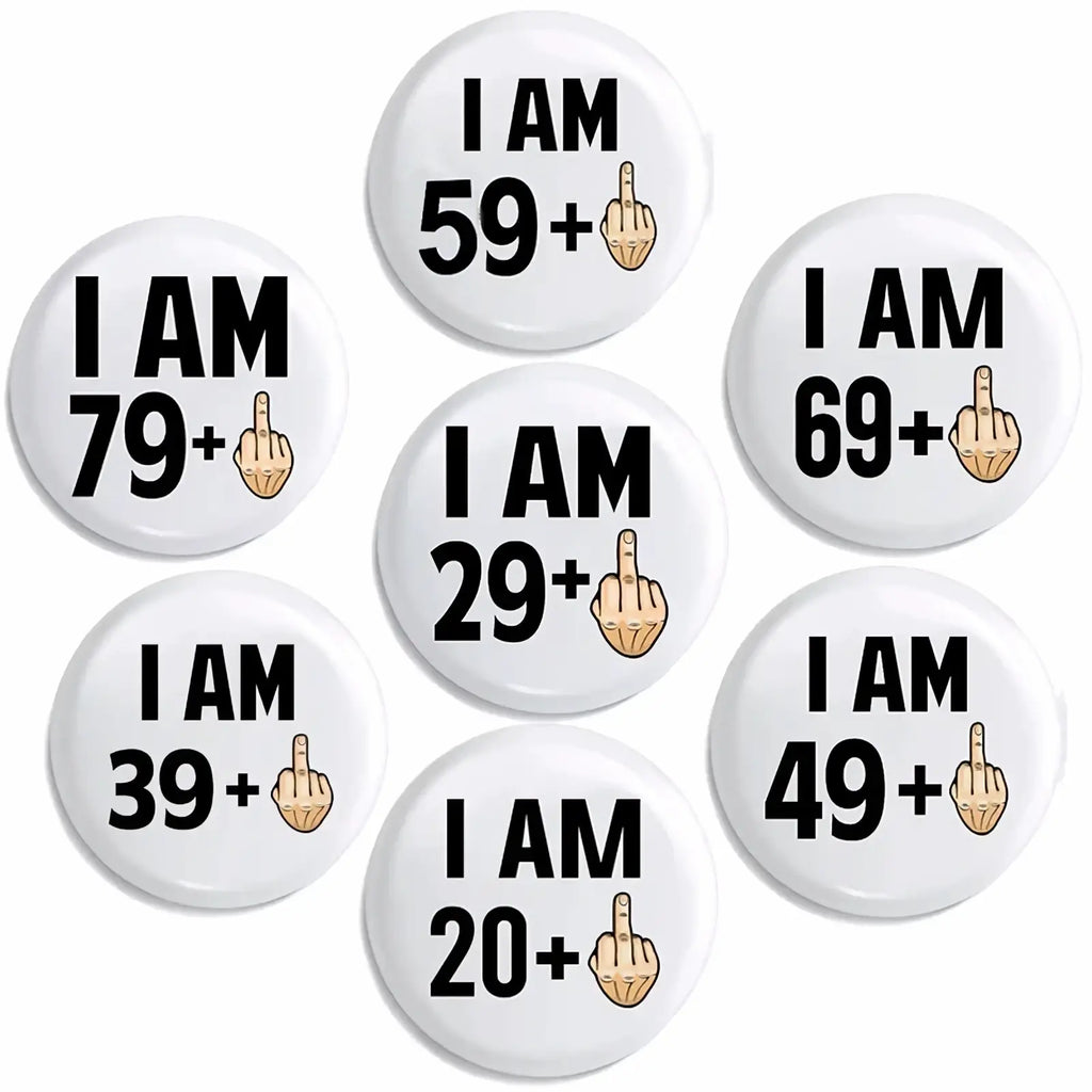 White circular funny age milestone birthday pin badges featuring black text and a cartoon middle finger emoji with age ranges
