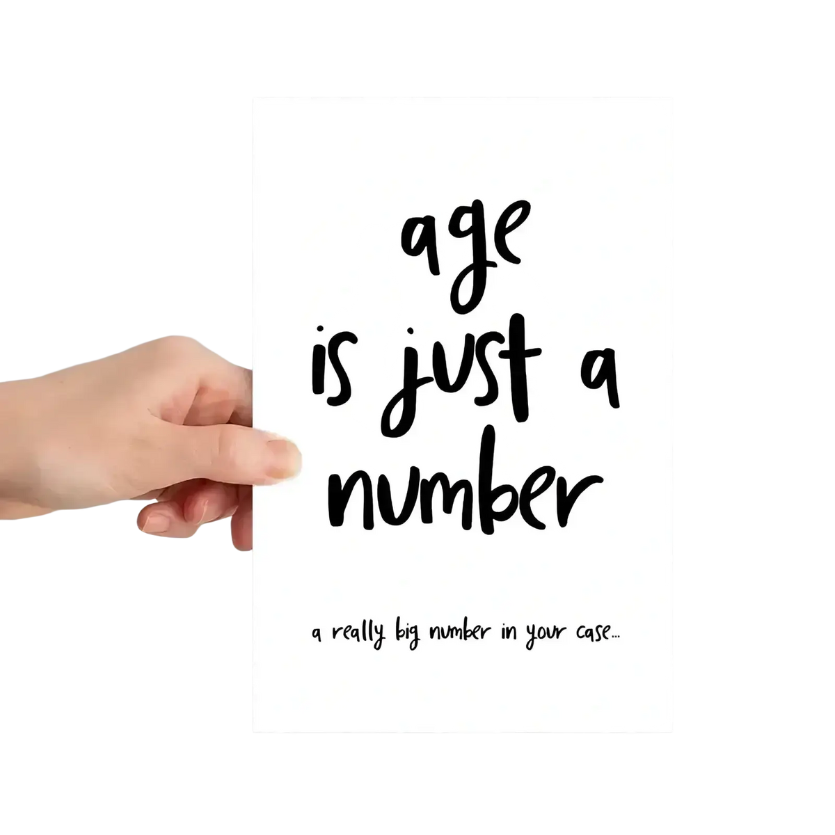 White rectangular birthday card with black handwritten-style funny age text saying age is just a number and a joke below