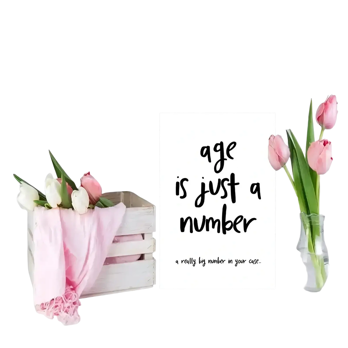 White wooden crate with pink and white tulips wrapped in pink shawl alongside funny age is just a number birthday card