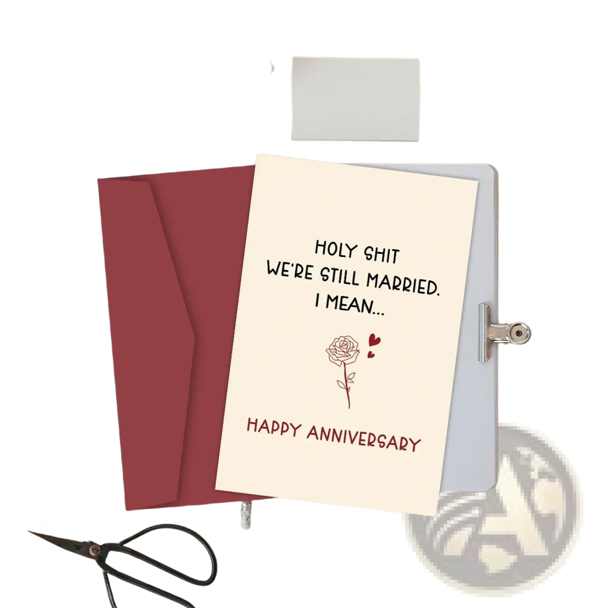 Cream-colored funny anniversary card for husband with black and red text reading holy shit we’re still married