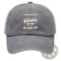 A faded gray denim cotton baseball cap with a funny embroidered quote in white and orange lettering