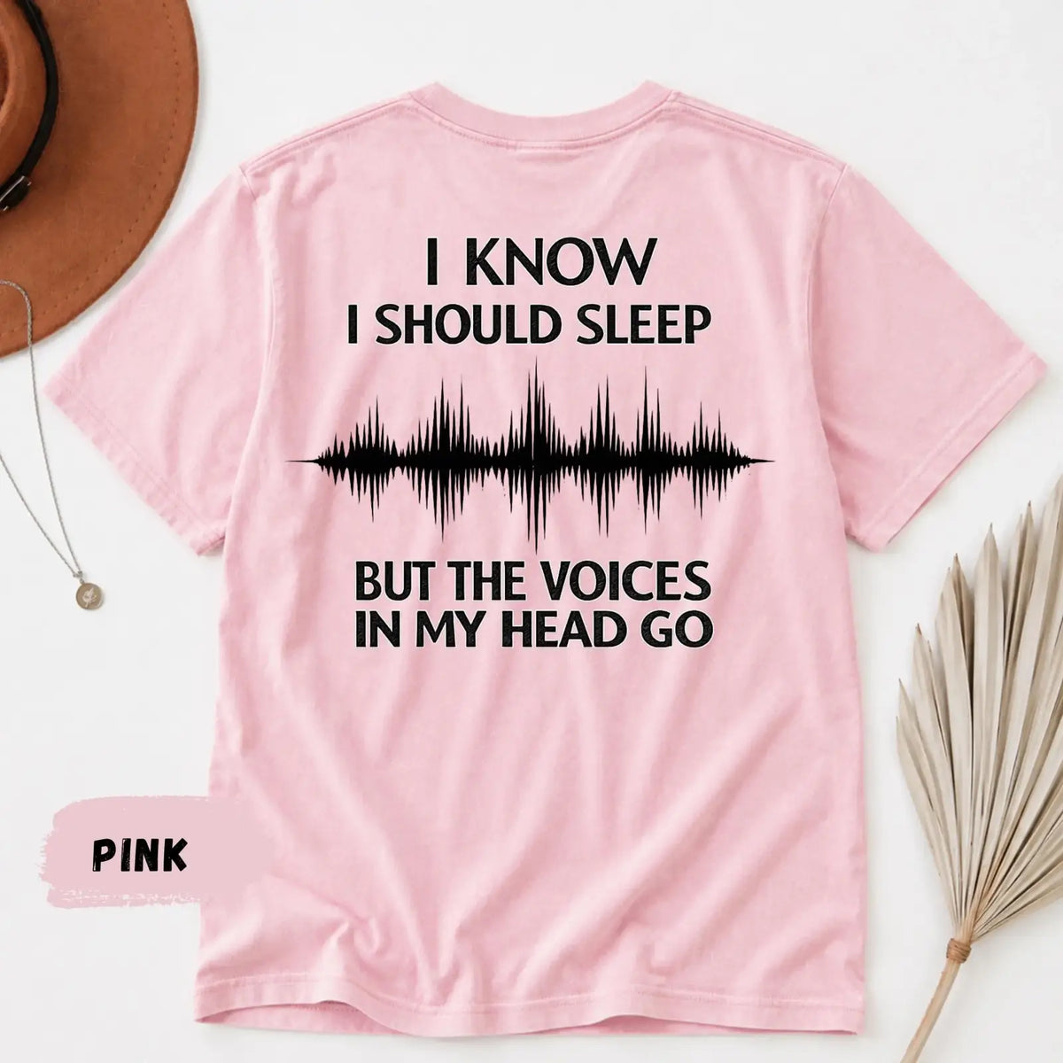 Pink short-sleeved t-shirt with black insomnia text and soundwave graphic on the back for dark humor sleep tee
