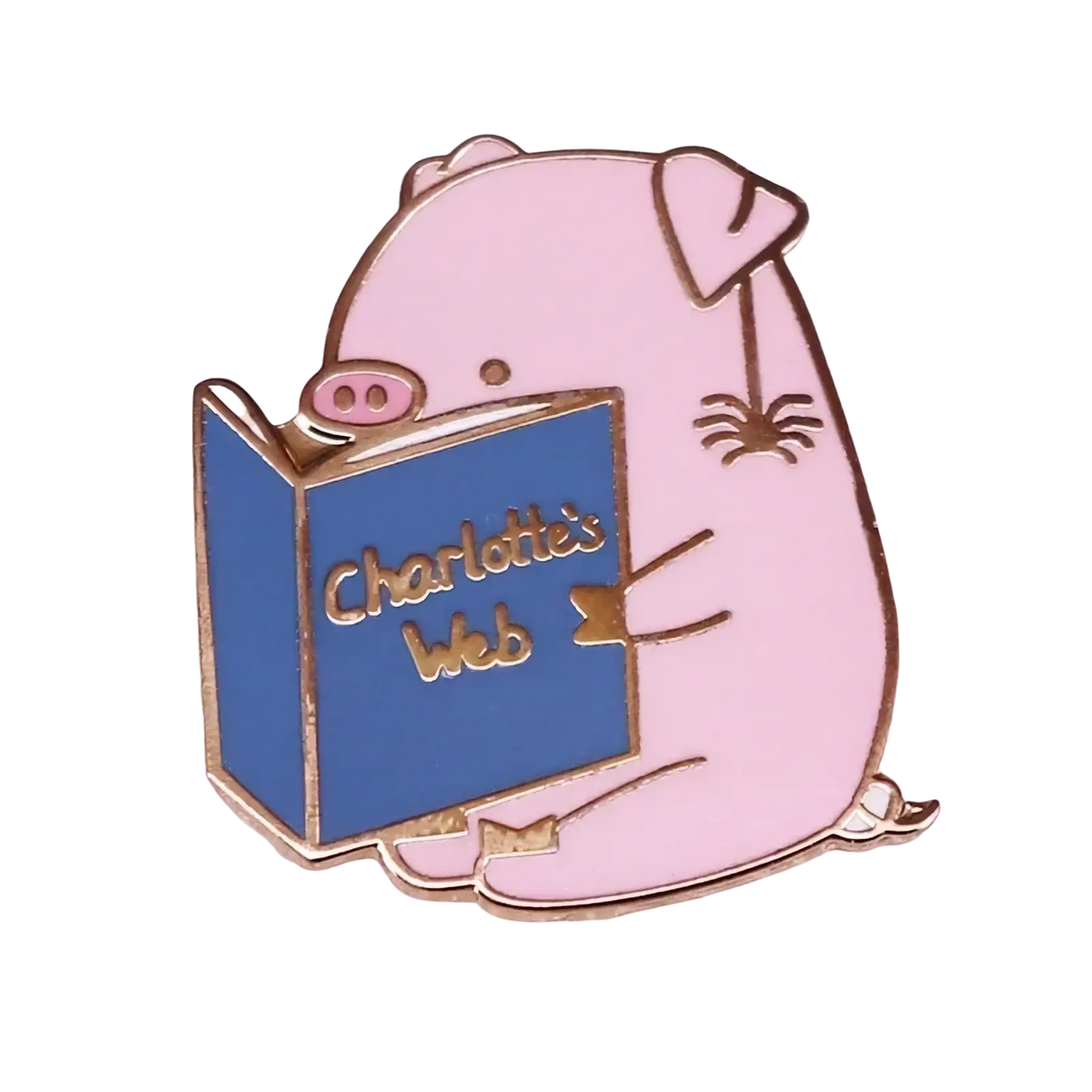 Pink enamel pin featuring a cartoon pig reading a blue charlottes web book with gold-trimmed edges and lettering