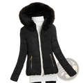 Black quilted puffer jacket for women with plush faux fur hood and gold-tone zippers for winter wear
