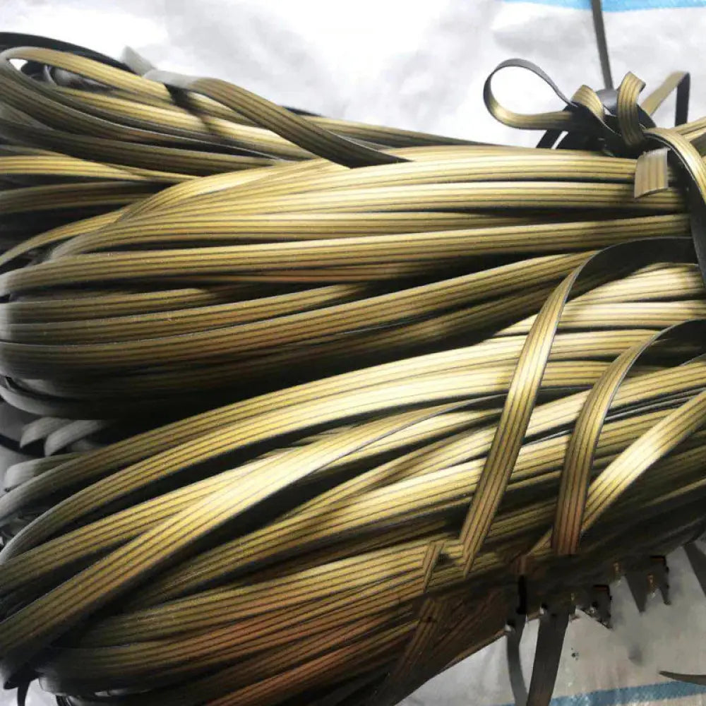 A bundle of gold and black striped leather straps tied together for premium rattan wicker repair and decoration