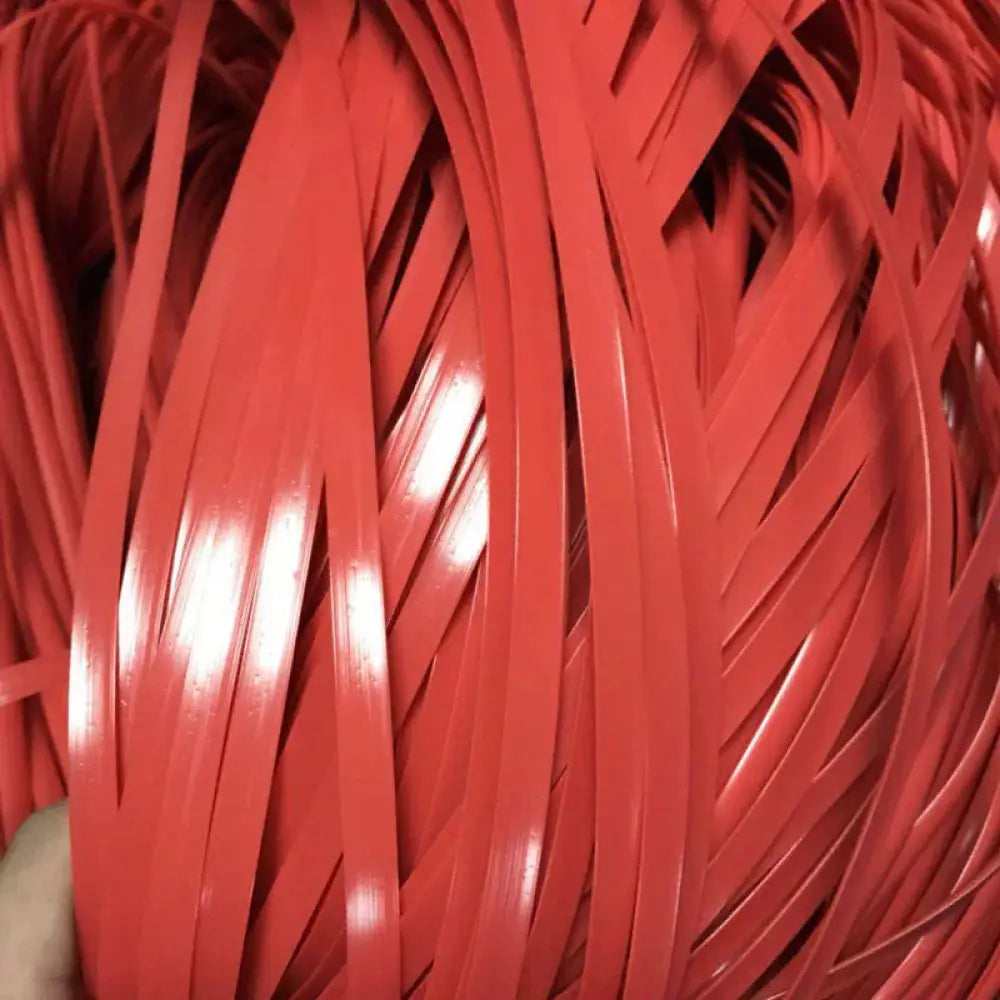 A bundle of glossy red plastic premium rattan wicker repair and decoration strips tightly woven together