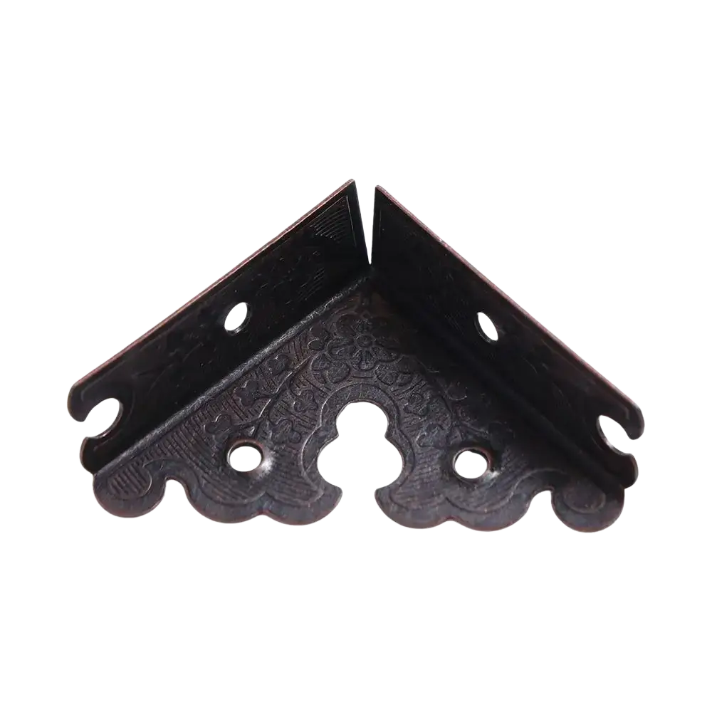 Dark bronze furniture protector corner bracket with intricate floral embossing and scalloped edges for antique brass furniture