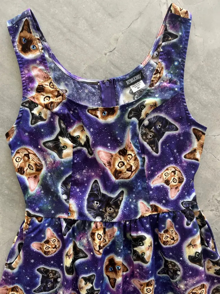 Purple galaxy-themed sleeveless fit and flare cotton dress with colorful cat face pattern galaxy cats design