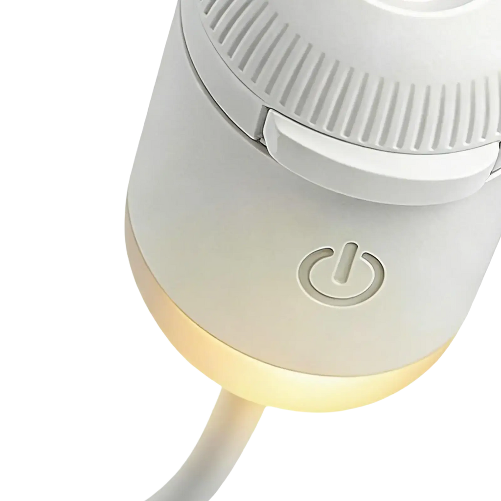 White cylindrical electric heater with glowing base and power button for galaxy projector night light use
