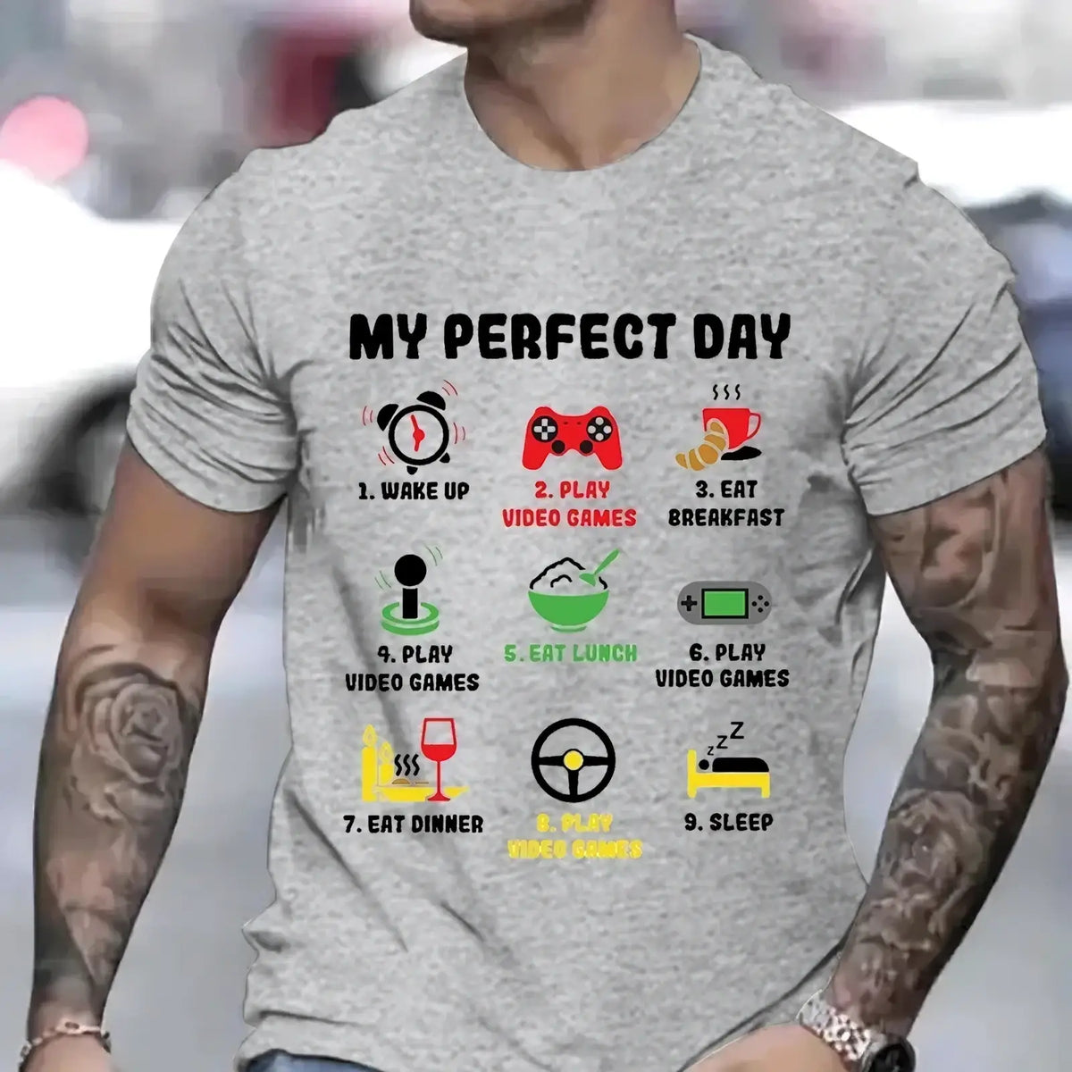 A heather gray short-sleeved t-shirt featuring a colorful gamer perfect day graphic outline with icons and text
