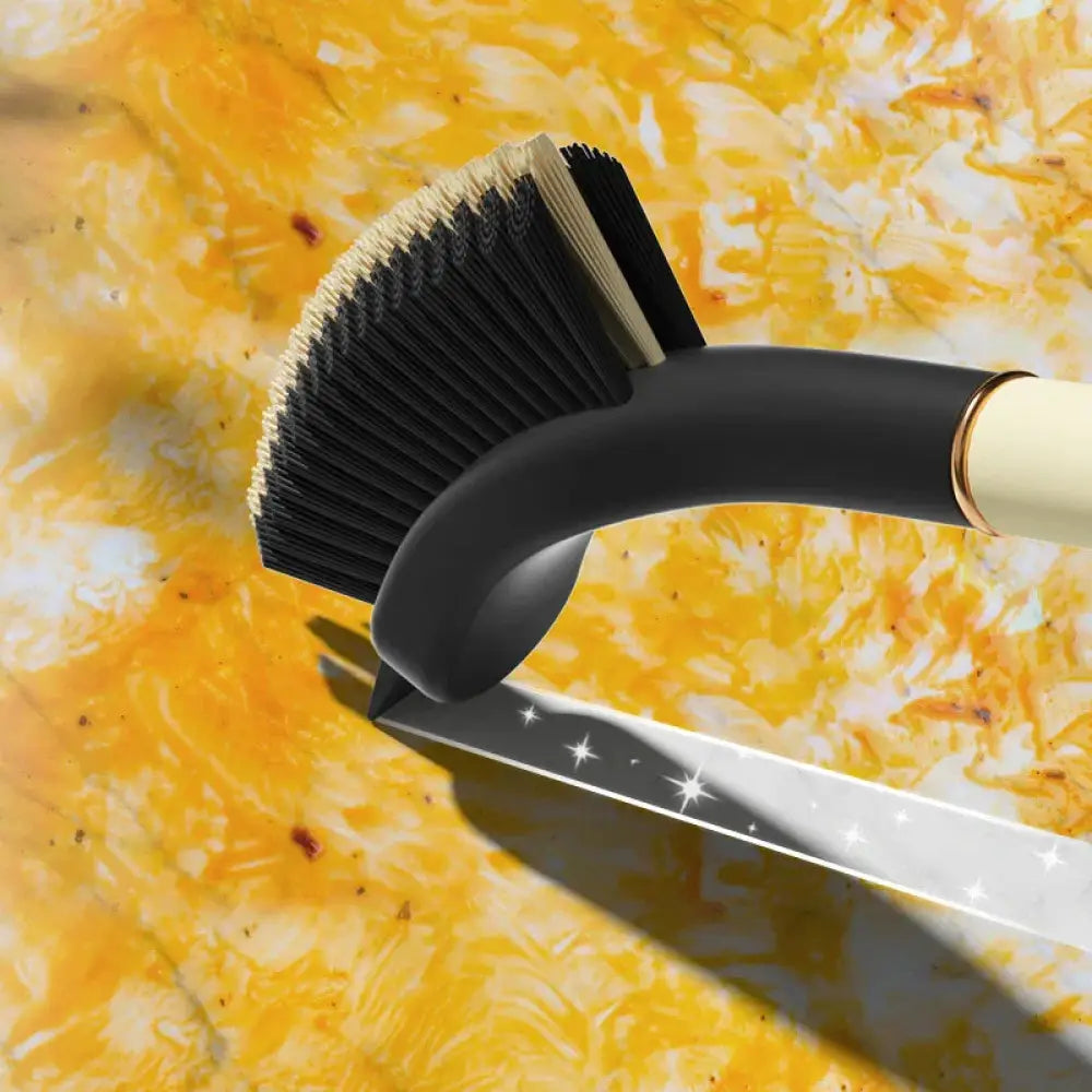 Black bristle brush with curved handle and gold accent ring from 3-in-1 crevice and gap cleaning brush set