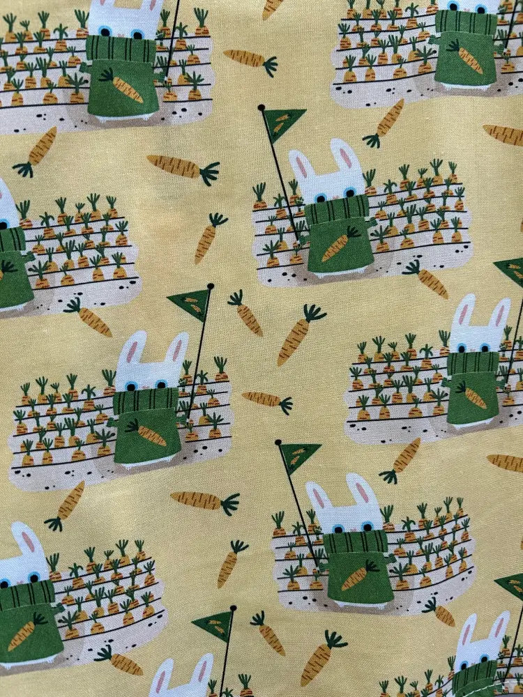 Garden bunny yellow cotton skater skirt with a repeating pattern of white bunnies in green scarves and orange carrots
