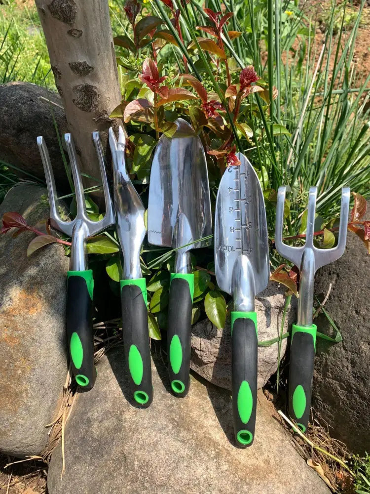 Set of five stainless steel garden tools with black and green ergonomic handles from 9 piece aluminum garden tool set