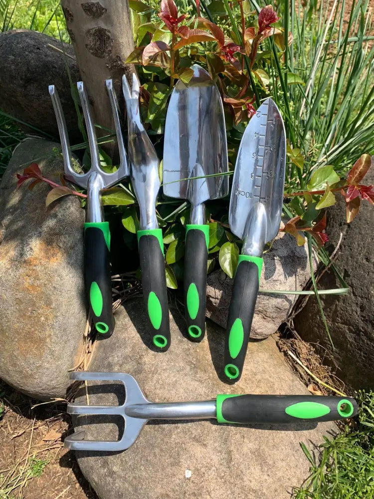Set of four stainless steel garden tools with black and green ergonomic handles from 9 piece aluminum garden set