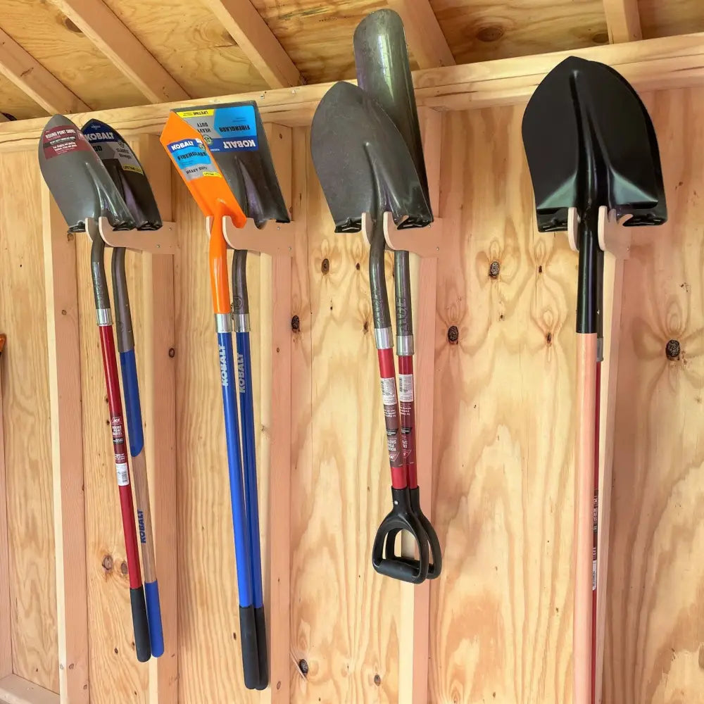 Black and red kobalt shovel with d-shaped handle on a stud mounted wave design wooden garden tool organizer