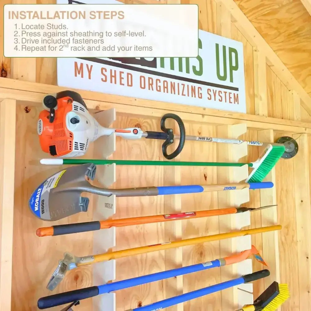 Orange and white gas-powered string trimmer mounted on birch wood stud mounted garden tool organizer rack