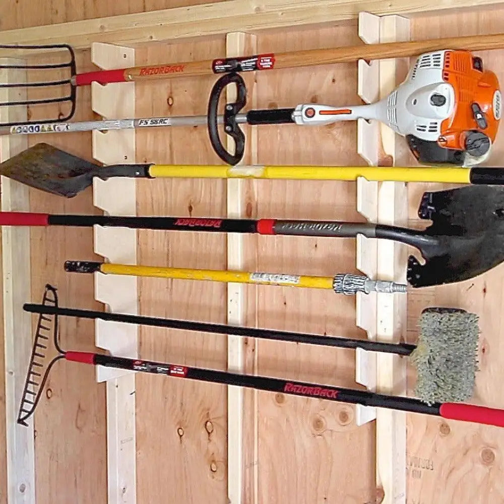 Orange and white Stihl string trimmer mounted on a birch wood stud mounted garden tool organizer rack