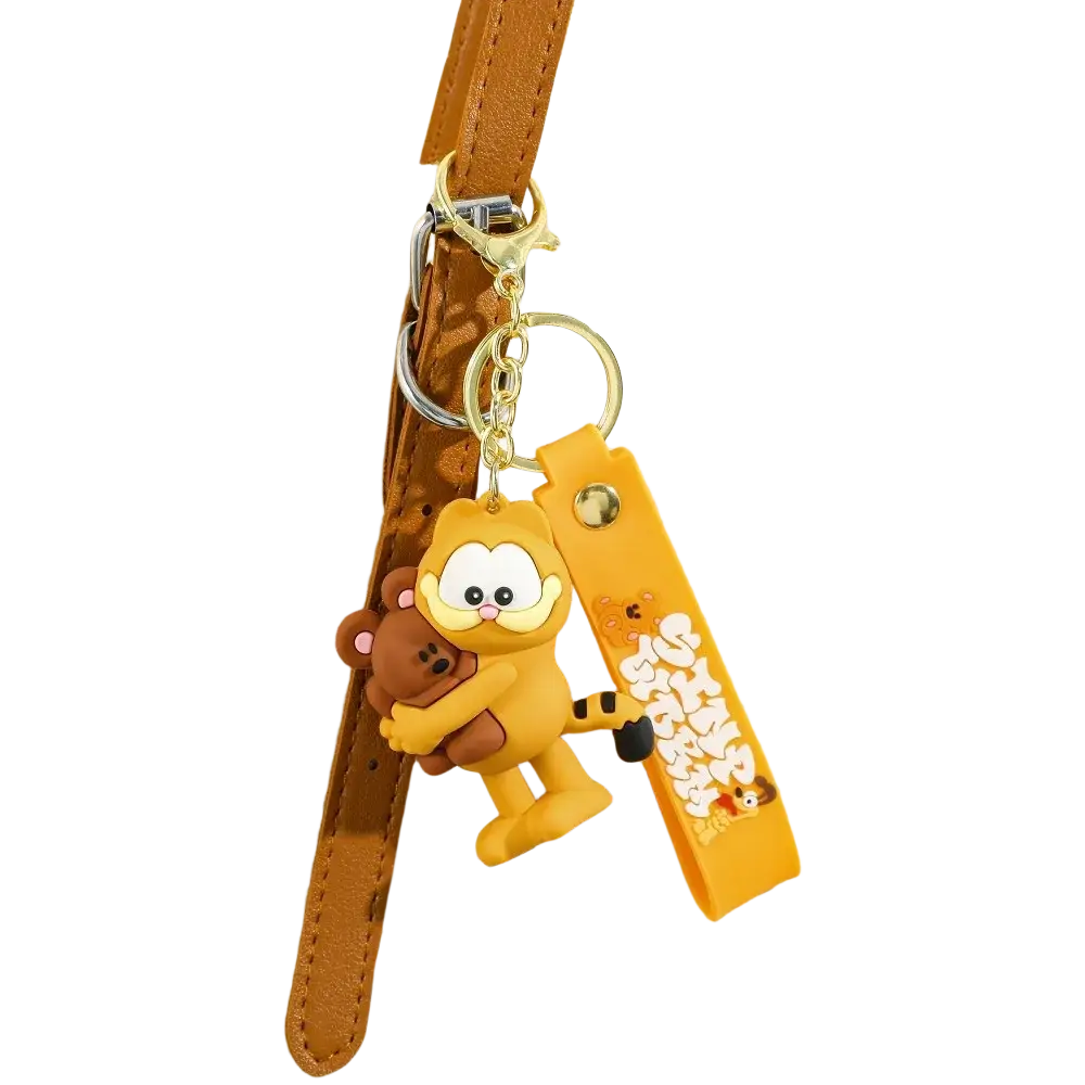 Yellow rubber Garfield keychain holding a brown teddy bear as an anime cat key pendant accessory