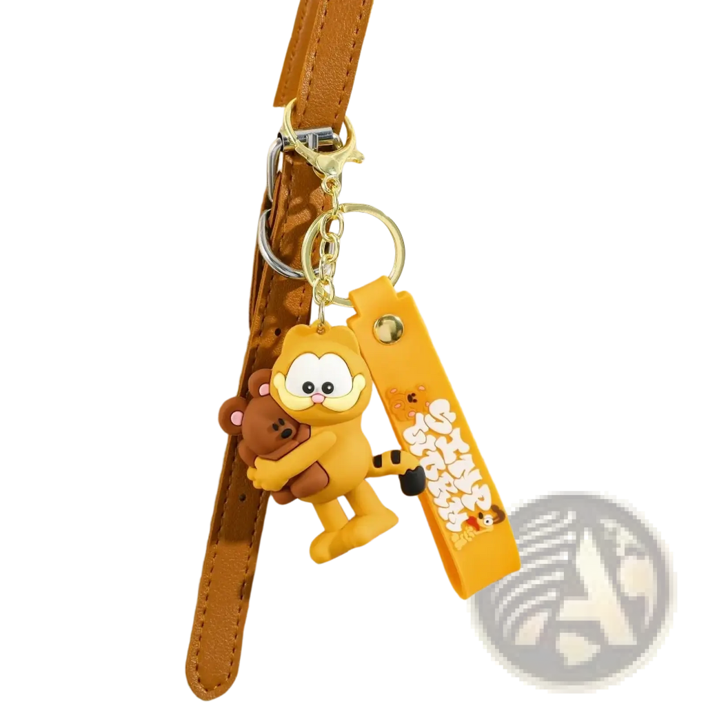 Yellow rubber Garfield keychain holding a brown teddy bear as an anime cat key pendant accessory