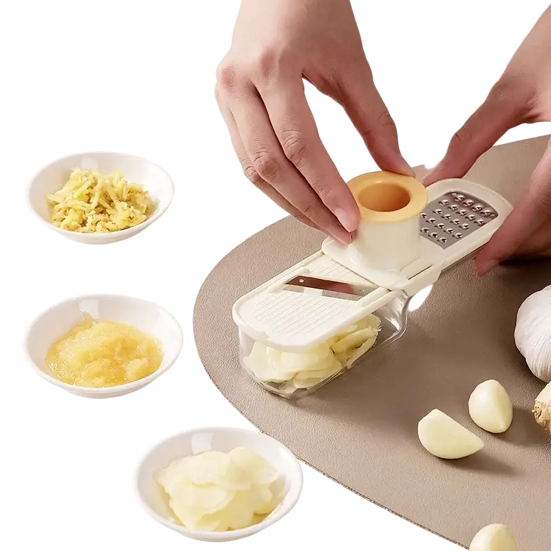 White plastic and stainless steel garlic grinder with interchangeable blades for garlic grinding and vegetable slicing