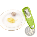 Green plastic garlic grater with stainless steel grating surface for mincing in a 2 pack set