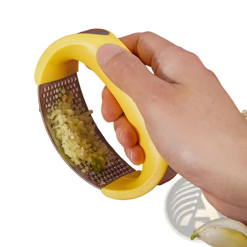 Yellow-handled stainless steel garlic press with ergonomic design filled with finely minced garlic for manual mincing