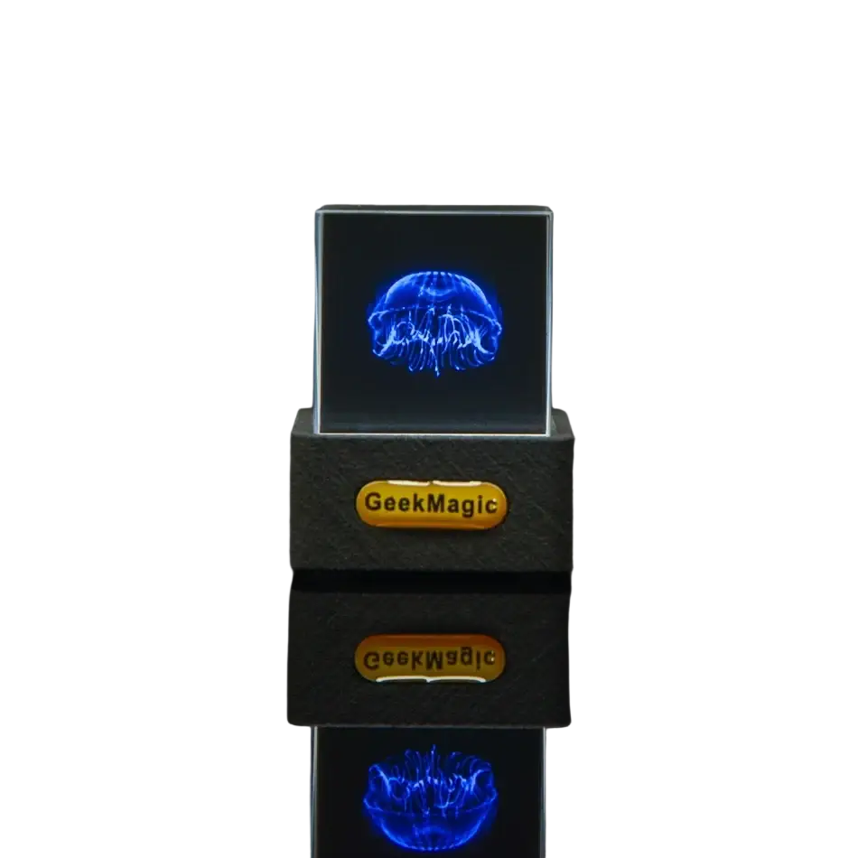 Geekmagic smart weather station crystal gif clock with a glowing blue jellyfish hologram in a transparent cube on a black base